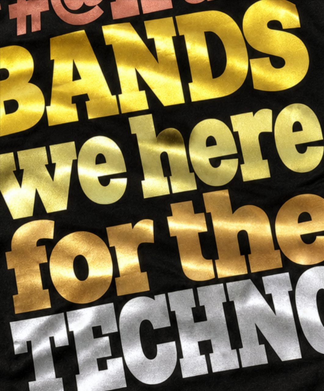 Close-up of gold and silver metallic lettering printed on a black tee